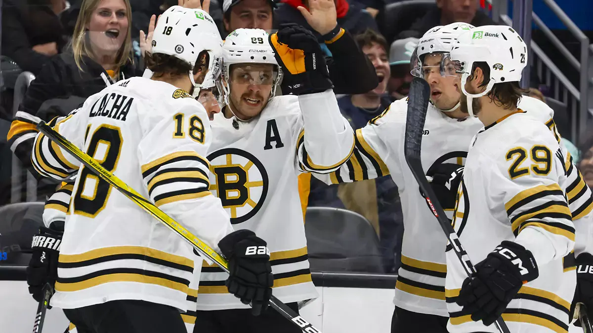 Boston Bruins right wing David Pastrnak (88, middle) celebrates with teammates after scoring a goal against the Seattle Kraken during the second period at Climate Pledge Arena.