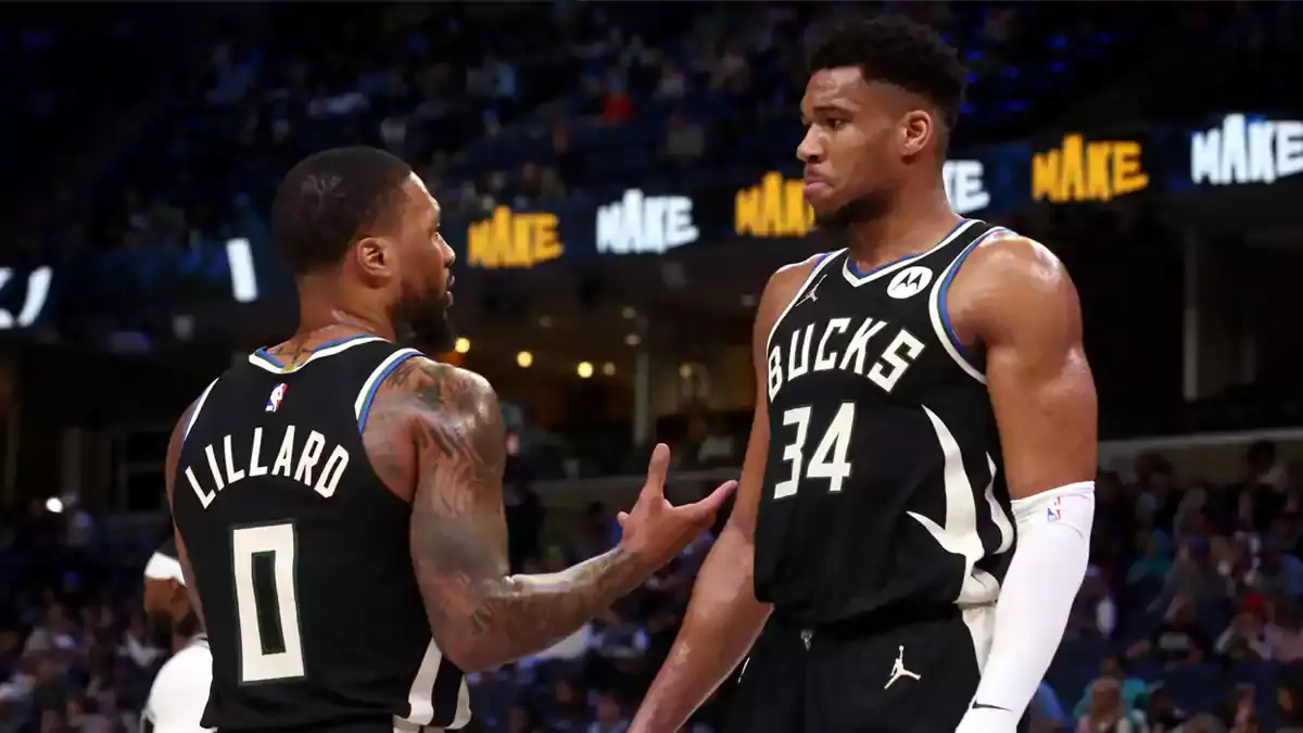 Milwaukee Bucks guard Damian Lillard (0) talks with forward Giannis Antetokounmpo (34) during a time out during the first half against the Memphis Grizzlies at FedExForum.