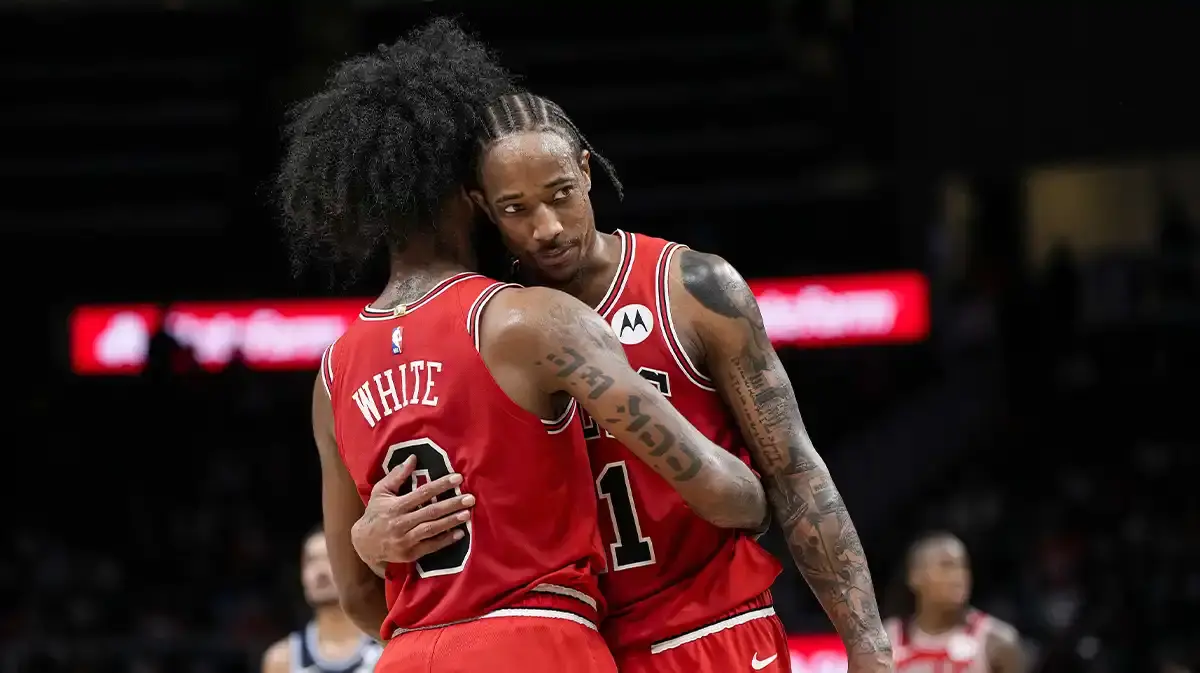 Chicago Bulls guard Coby White (0) and forward DeMar DeRozan (11) react near the end of the game against the Atlanta Hawks during the second half at State Farm Arena.
