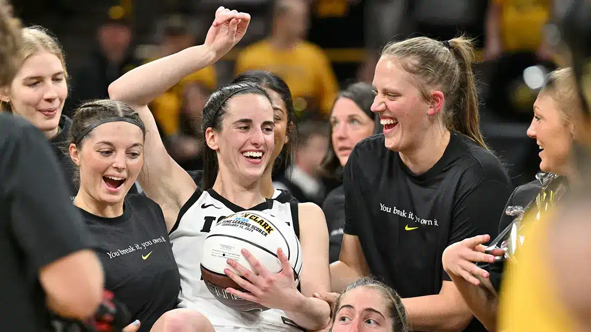 Iowa Hawkeyes guard Caitlin Clark (holding ball) reacts with teammates after the game against the Michigan Wolverines at Carver-Hawkeye Arena. Clark broke the NCAA women's all-time scoring record during the game.