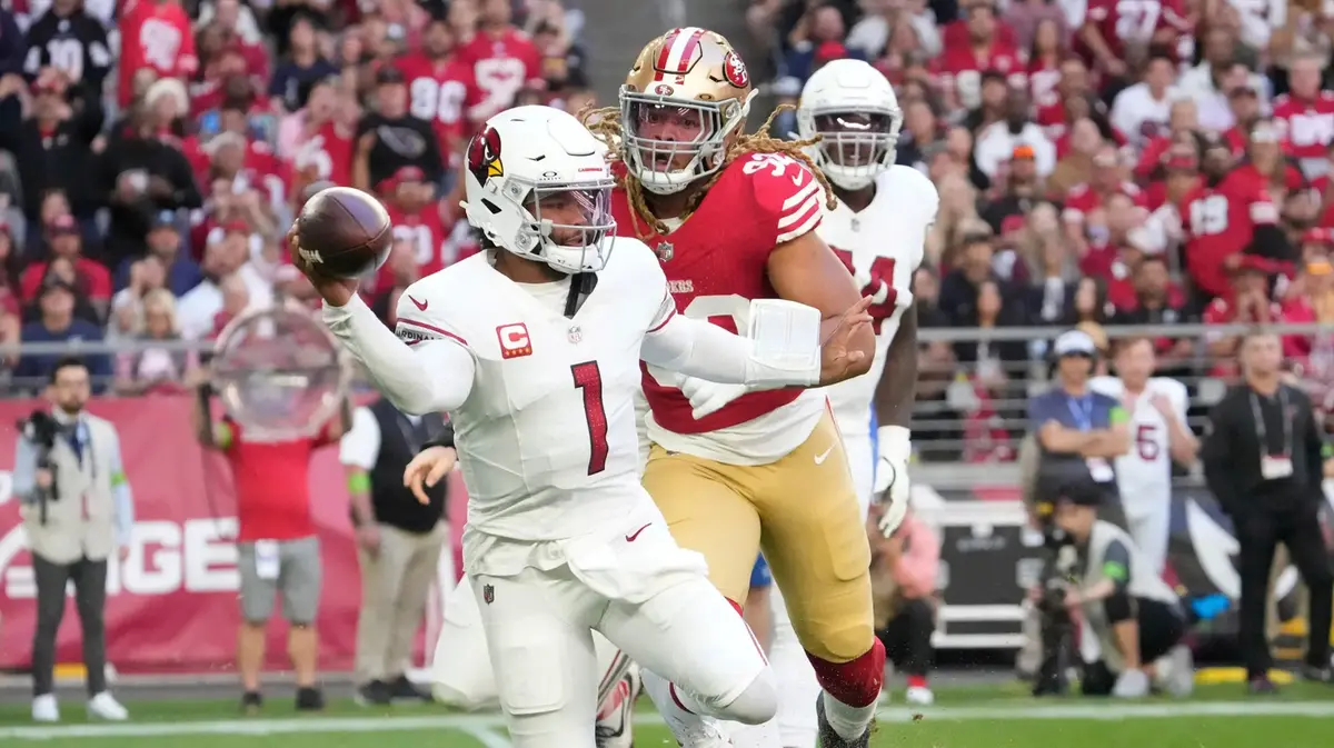 Arizona Cardinals quarterback Kyler Murray (1) throws the ball away while pursued by San Francisco 49ers defensive end Chase Young (92) during the first quarter at State Farm Stadium