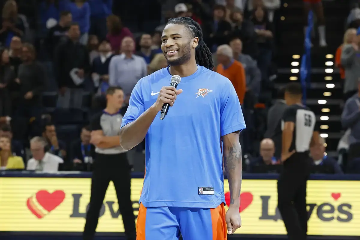 Oklahoma City Thunder guard Cason Wallace (22) talks to fans before the start of a game against the Denver Nuggets at Paycom Center.