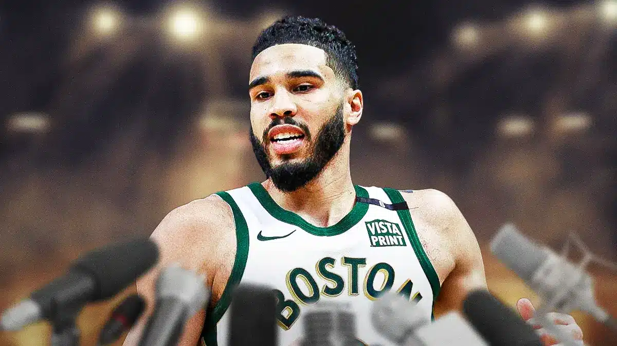 Boston Celtics forward Jayson Tatum with a microphone in front of him.