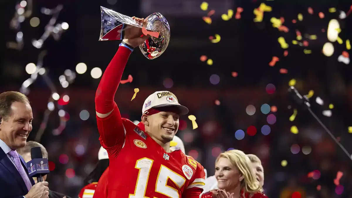 Kansas City Chiefs quarterback Patrick Mahomes (15) celebrates with the Vince Lombardi Trophy after defeating the San Francisco 49ers in overtime of Super Bowl LVIII at Allegiant Stadium