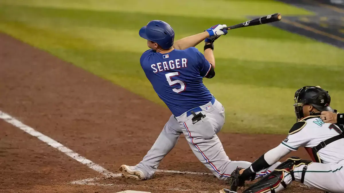 Texas Rangers shortstop Corey Seager (5) hits a single in the seventh inning against the Arizona Diamondbacks in game five of the 2023 World Series at Chase Field.