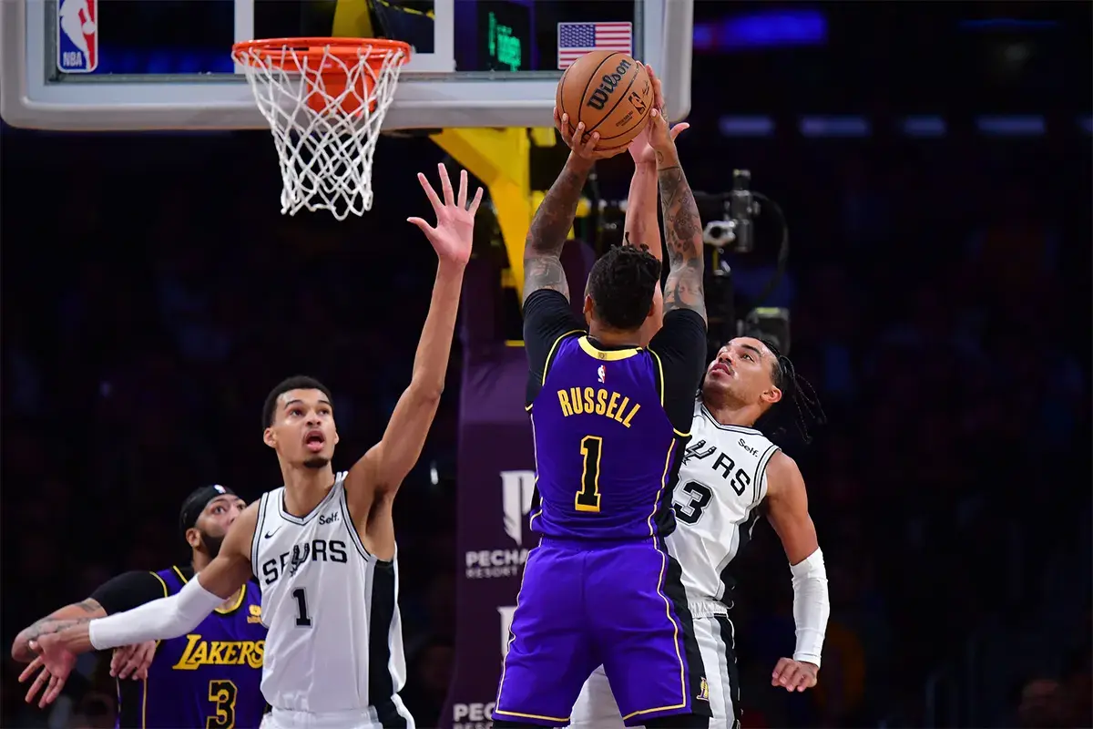 Los Angeles Lakers guard D'Angelo Russell (1) shoots against San Antonio Spurs center Victor Wembanyama (1) and guard Tre Jones (33) during the second half at Crypto.com Arena.