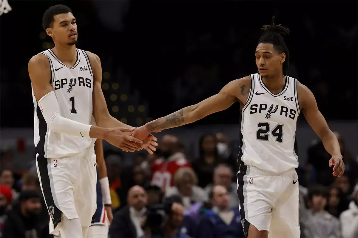 San Antonio Spurs center Victor Wembanyama (1) celebrates with San Antonio Spurs guard Devin Vassell (24) against the Washington Wizards during the final seconds in the second half at Capital One Arena.