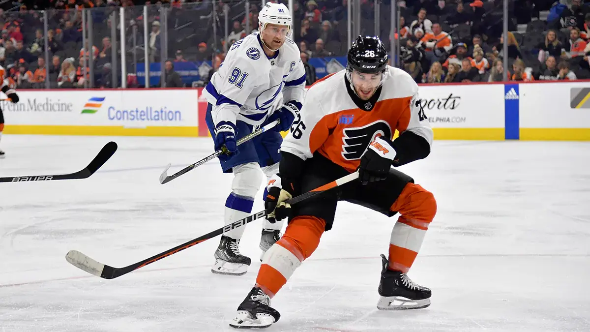 Philadelphia Flyers defenseman Sean Walker (26) and Tampa Bay Lightning center Steven Stamkos (91) battle for the puck during the second period at Wells Fargo Center.