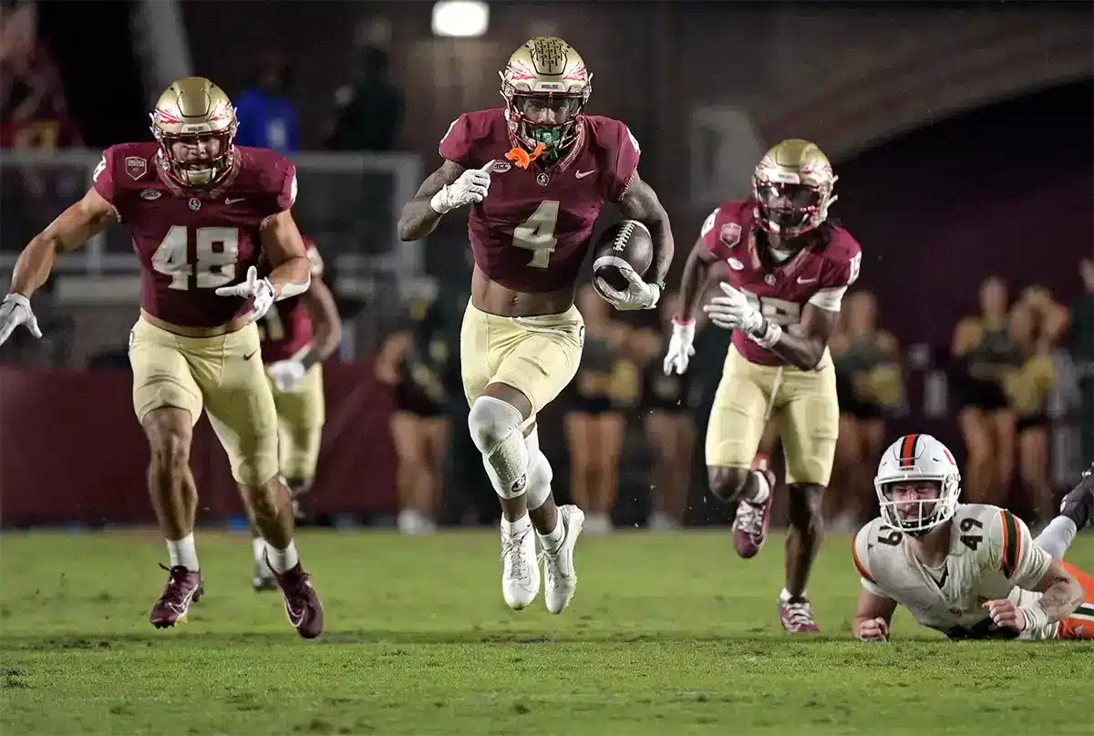 Florida State Seminoles wide receiver Keon Coleman (4) returns a punt in the second half against the Miami Hurricanes at Doak S. Campbell Stadium. 