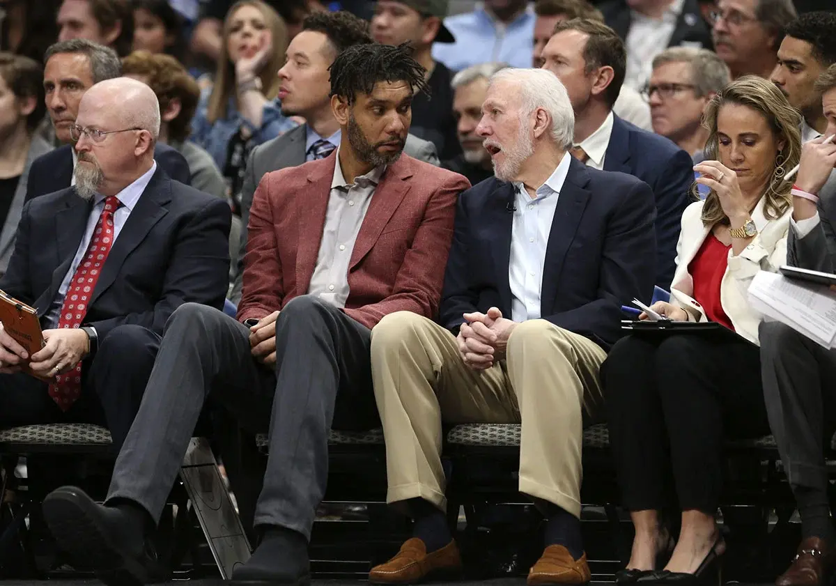 San Antonio Spurs assistant coach Tim Duncan speaks with San Antonio Spurs head coach Gregg Popovich during the fourth quarter at American Airlines Center