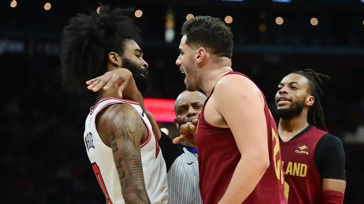 Chicago Bulls guard Coby White (0) and Cleveland Cavaliers forward Georges Niang (20) have words as referee Michael Smith (38) tries to get between them during the second half at Rocket Mortgage FieldHouse.