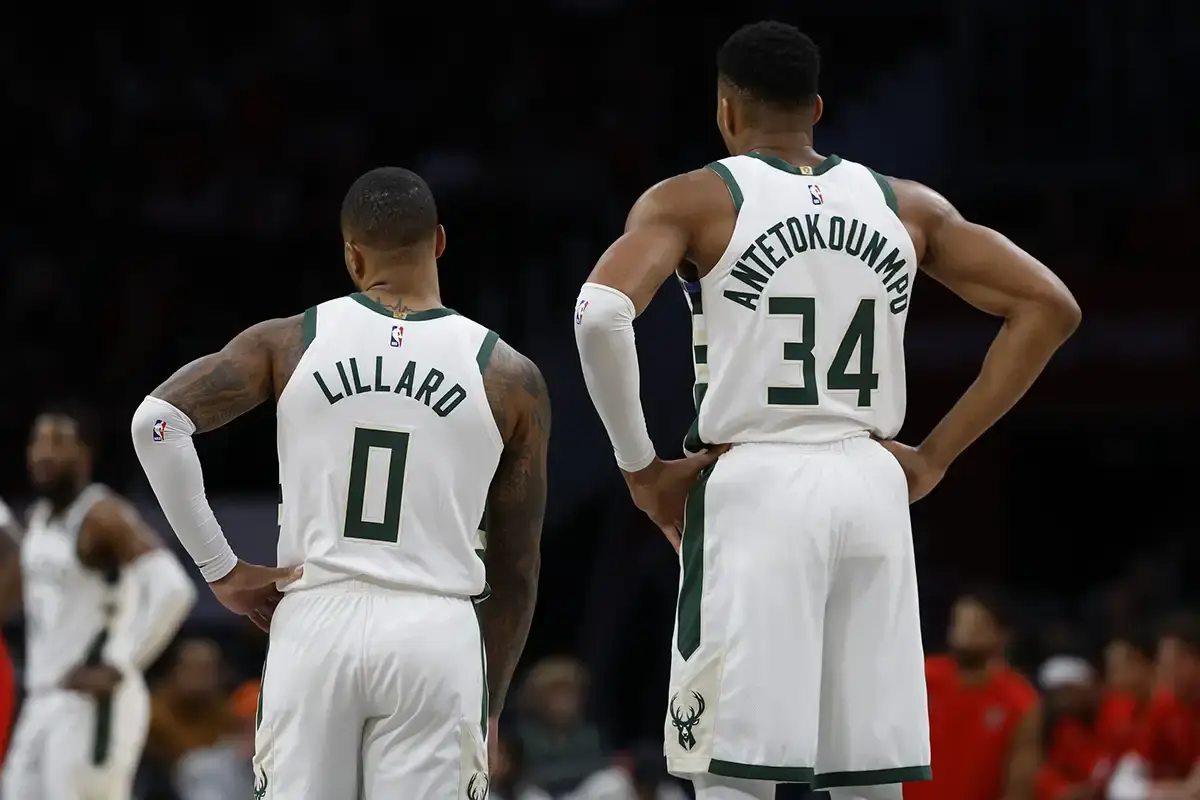 Milwaukee Bucks guard Damian Lillard (0) and Bucks forward Giannis Antetokounmpo (34) stand on the court against the Washington Wizards in the second quarter at Capital One Arena