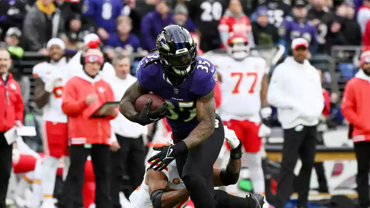 Baltimore Ravens running back Gus Edwards (35) runs with the ball against the Kansas City Chiefs during the first half in the AFC Championship football game at M&T Bank Stadium