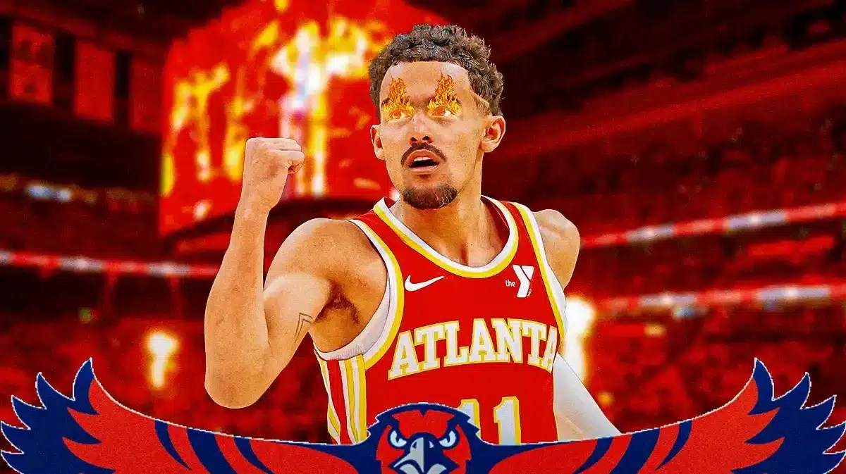Hawks' Trae Young with fire in his eyes. Hawks' fans in background cheering looking happy.