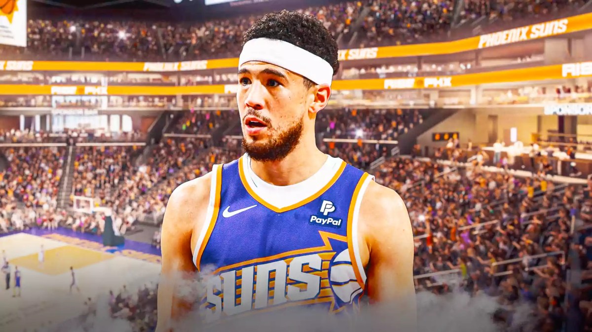 Devin Booker with he Suns arena in the background
