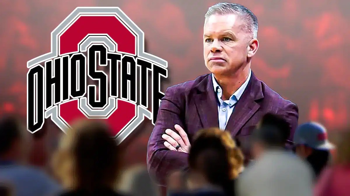 Chris Holtmann with the Ohio State logo in the background, firing
