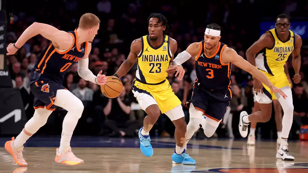 Indiana Pacers forward Aaron Nesmith (23) brings the ball up court against New York Knicks guards Donte DiVincenzo (0) and Josh Hart (3) during the first quarter at Madison Square Garden. Mandatory