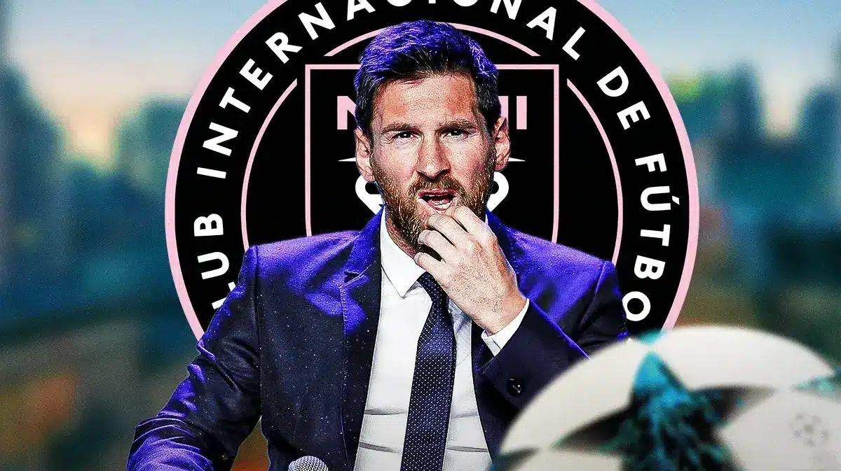 Lionel Messi sitting on the bench with his head down in front of the Inter Miami logo