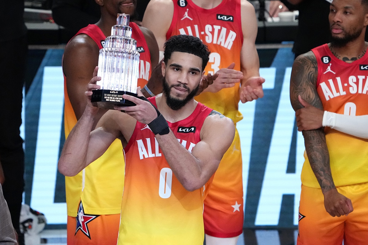 Jayson Tatum holding up the 2023 All-Star Game MVP trophy