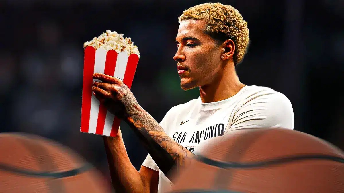 Spurs forward Jeremy Sochan eating popcorn