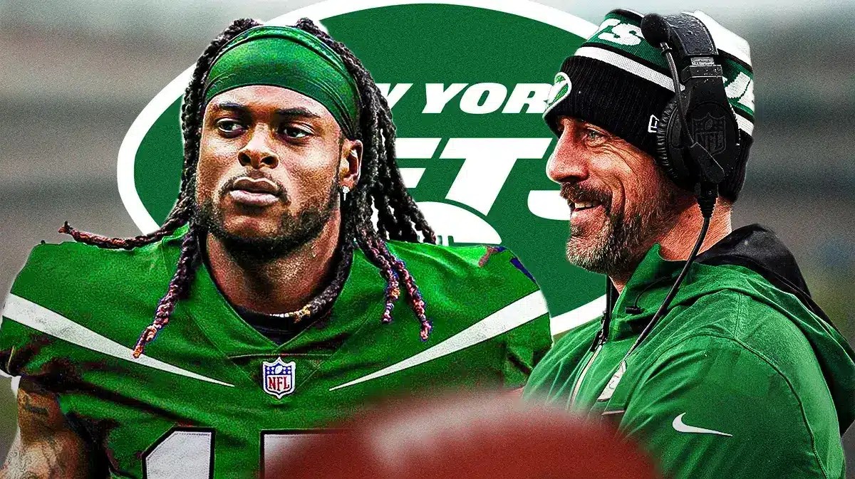 Jets Aaron Rodgers smiling at Davante Adams in a Jets jersey in front of a Jets logo