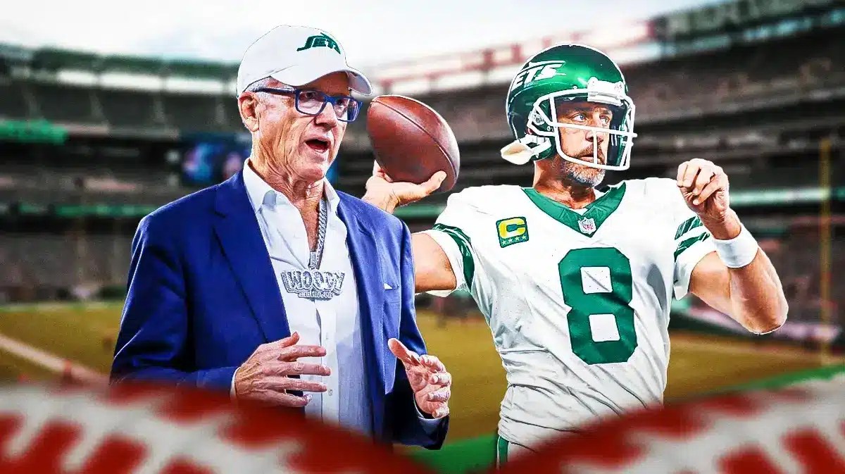 Jets owner Woody Johnson all smiles looking at Aaron Rodgers in Jets legacy throwback uniforms.