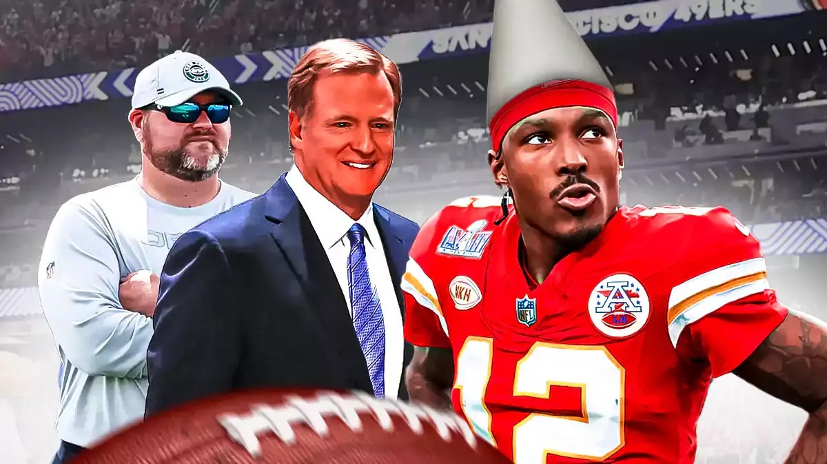 Jets' Joe Douglas standing behind Roger Goodell. They are looking at Mecole Hardman, who is wearing a dunce cap.