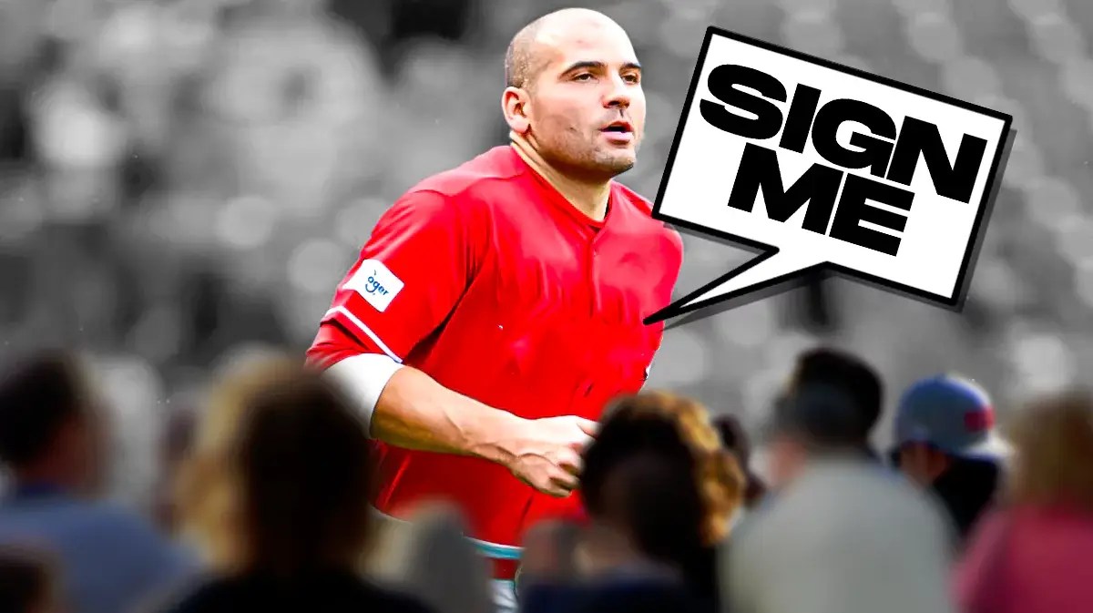 Photo: Joey Votto with a tear in his eye in blank jersey saying “Sign me”