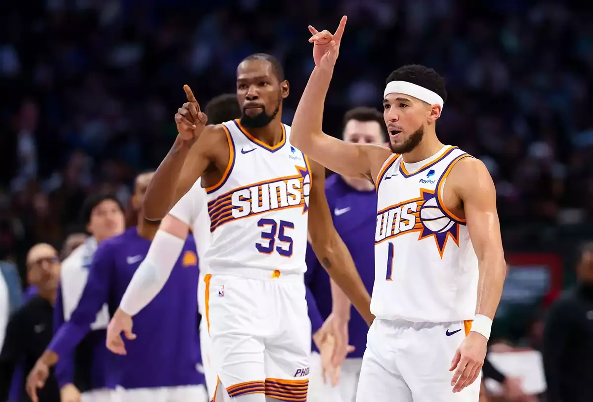 Phoenix Suns guard Devin Booker (1) celebrates with Phoenix Suns forward Kevin Durant (35) during the third quarter against the Dallas Mavericks at American Airlines Center.