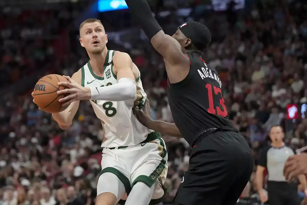 Boston Celtics center Kristaps Porzingis (8) goes up for a shot against Miami Heat center Bam Adebayo (13) during the first half at Kaseya Center