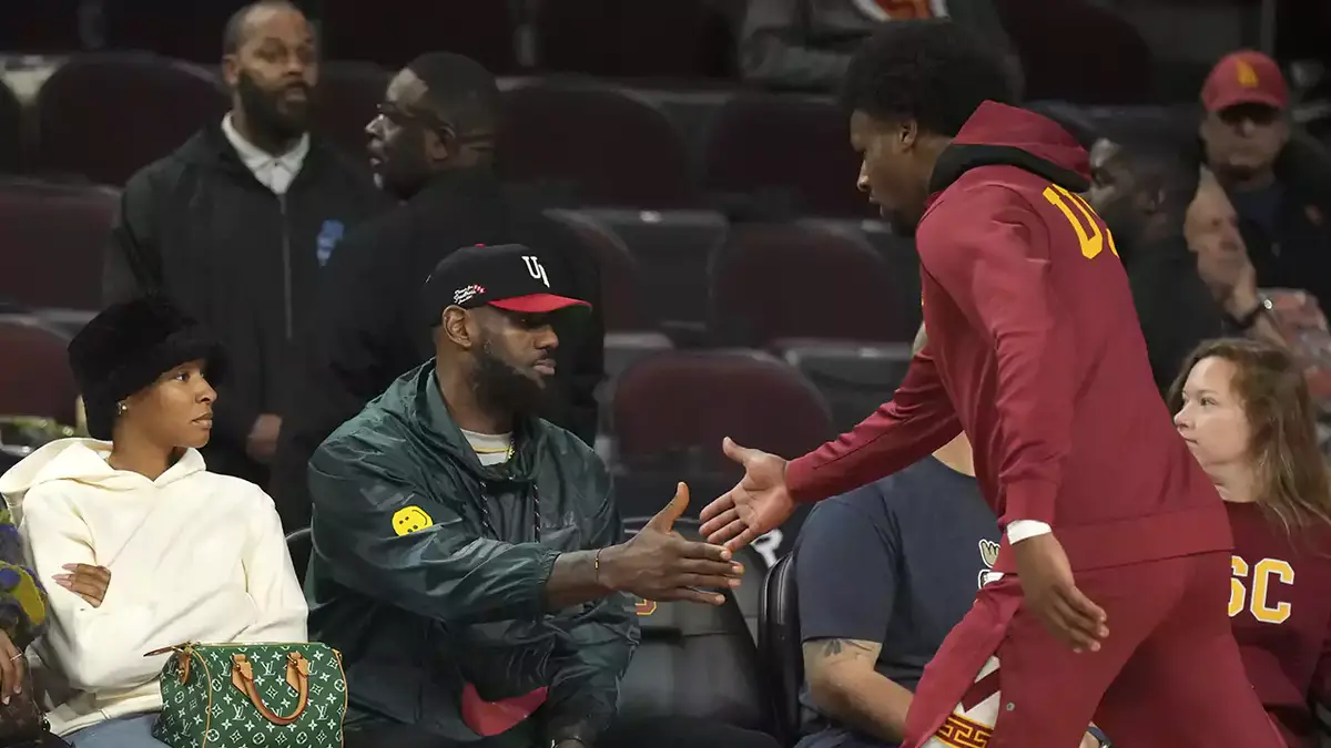  Southern California Trojans guard Bronny James (6) is greeted by father LeBron James during the game against the Washington State Cougars at Galen Center. 