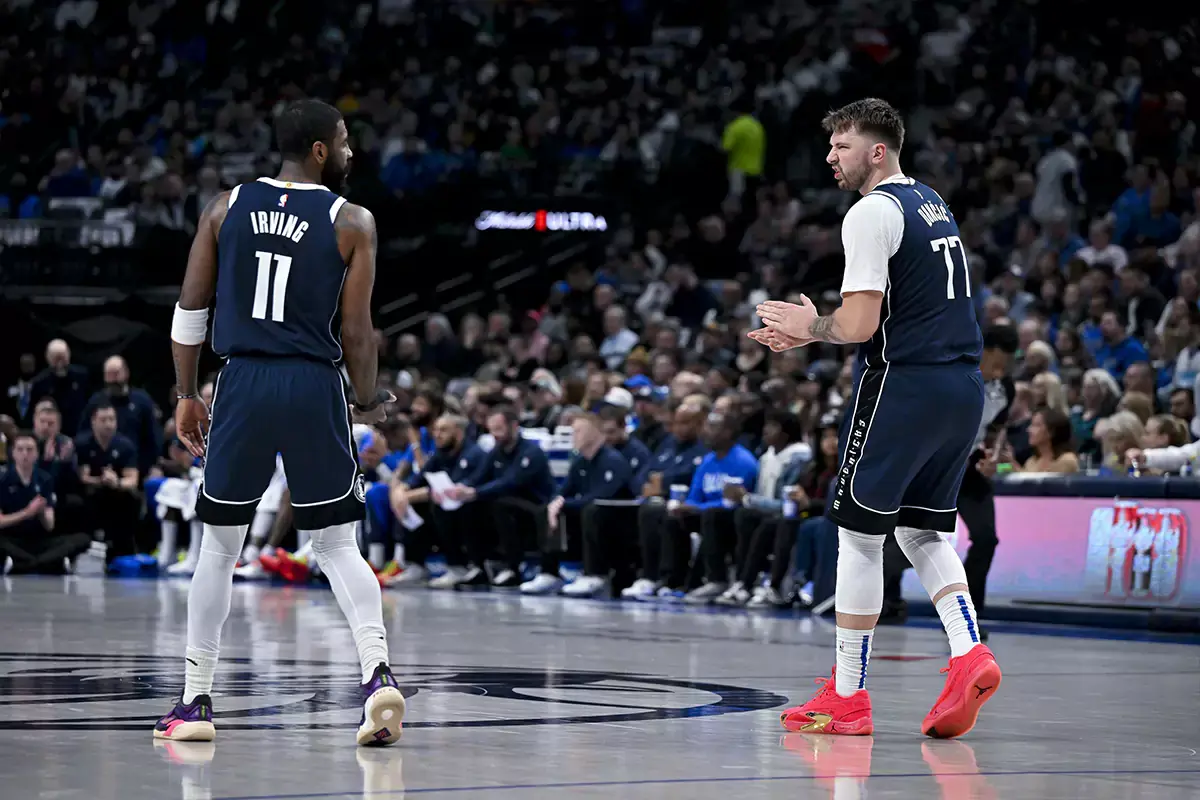 Dallas Mavericks guard Kyrie Irving (11) talks with guard Luka Doncic (77) during the second quarter against the Washington Wizards at the American Airlines Center. 