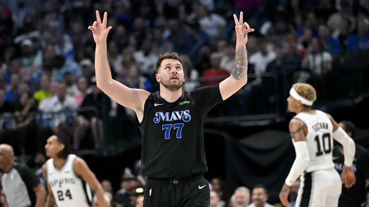 Dallas Mavericks guard Luka Doncic (77) celebrates after forward Tim Hardaway Jr. (not pictured) makes a three point shot against the San Antonio Spurs during the second half at the American Airlines Center. 