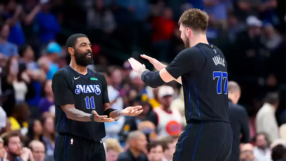Dallas Mavericks guard Kyrie Irving (11) celebrates with Dallas Mavericks guard Luka Doncic (77) during the second half against the Phoenix Suns at American Airlines Center