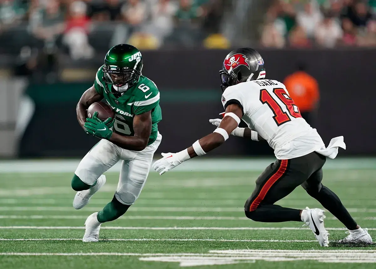 New York Jets wide receiver Mecole Hardman Jr. (6) runs with the ball with pressure from Tampa Bay Buccaneers cornerback Keenan Isaac (16) in the first half of a preseason NFL game at MetLife Stadium on Saturday, Aug. 19, 2023, in East Rutherford.