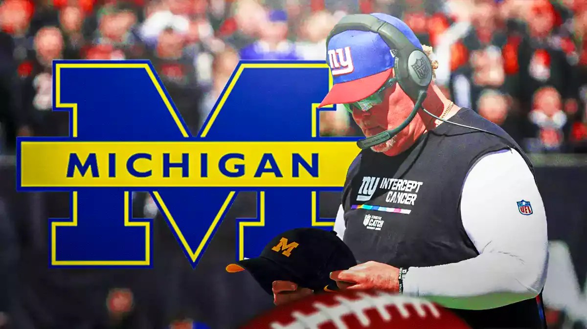 Wink Martindale holding a Michigan football hat.