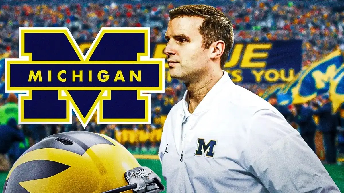 Photo: Sean Magee in Michigan gear with Michigan logo behind him