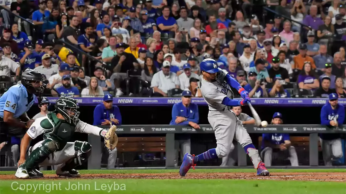 Los Angeles Dodgers second baseman Mookie Betts (50) hits a RBI single in the fifth inning agains the Colorado Rockies at Coors Field.