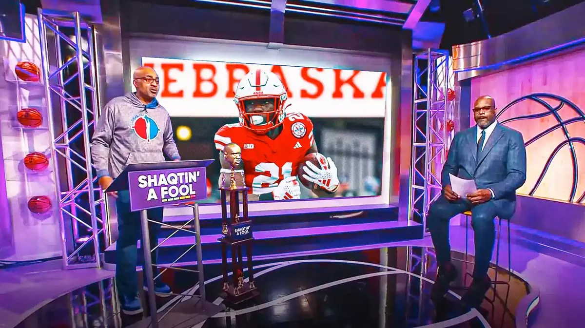 Replace the big Shaqtin a Fool midseason awards text in the background with image of Emmett Johnson (Nebraska football running back)