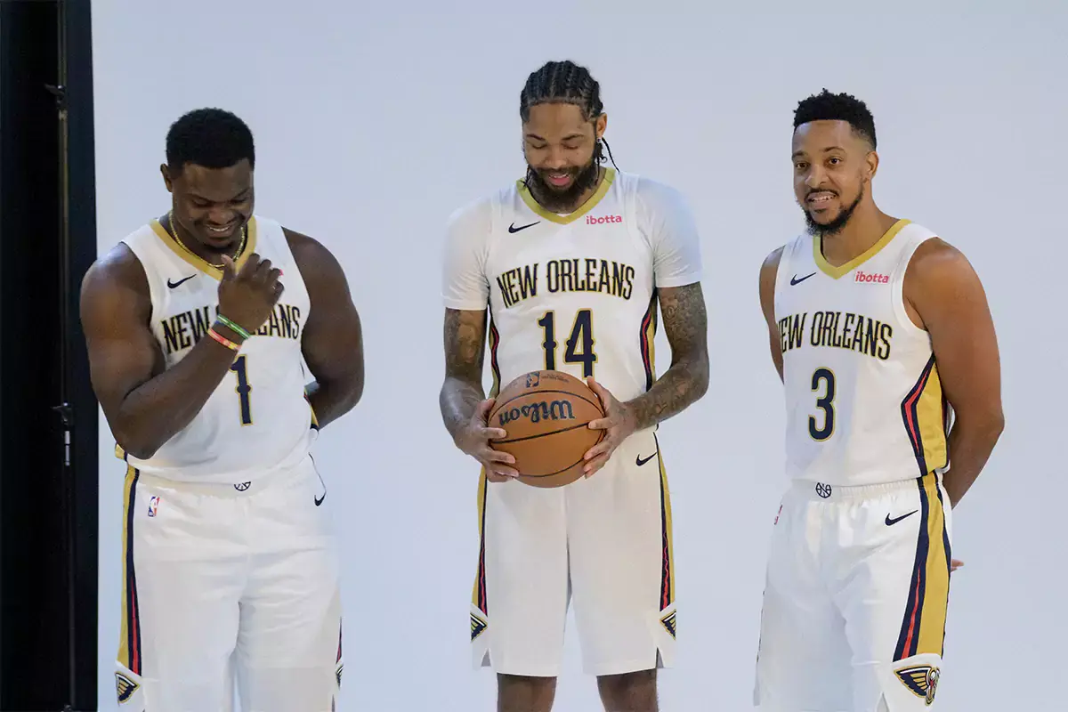 New Orleans Pelicans forward Zion Williamson (1), forward Brandon Ingram (14), and guard CJ McCollum (3) giggle as they pose during Pelicans media day at the Smoothie King Center. 