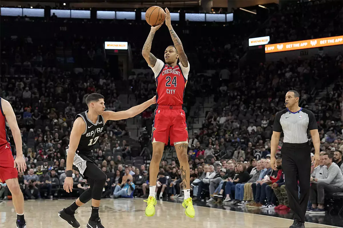 New Orleans Pelicans guard Jordan Hawkins (24) shoots over San Antonio Spurs forward Doug McDermott (17) during the first half at Frost Bank Center. 