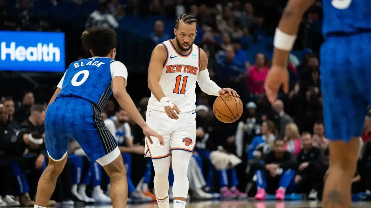 Knicks guard Jalen Brunson (11) dribbles the ball against Orlando Magic guard Anthony Black (0) in the first quarter at KIA Center.