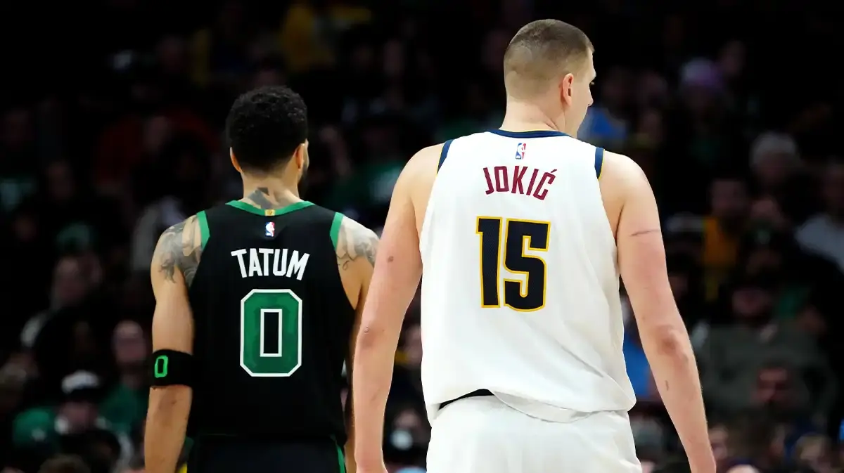 Denver Nuggets center Nikola Jokic (15) and Boston Celtics forward Jayson Tatum (0) during the second half at Ball Arena.