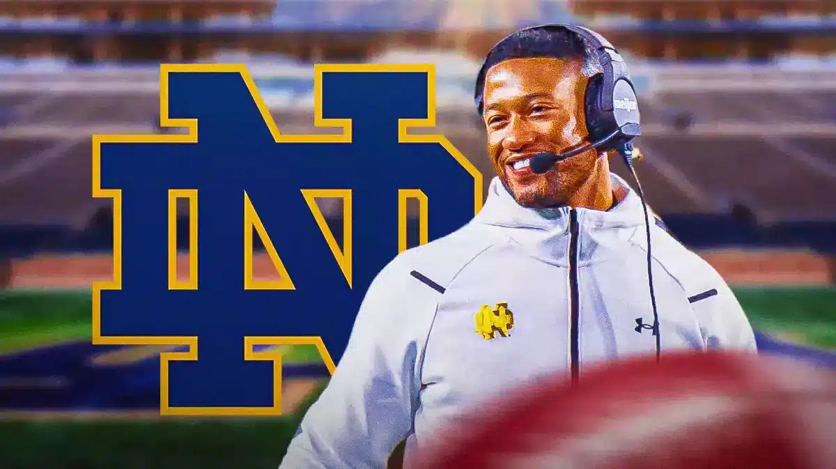 Marcus Freeman next to a Notre Dame logo at Notre Dame Stadium