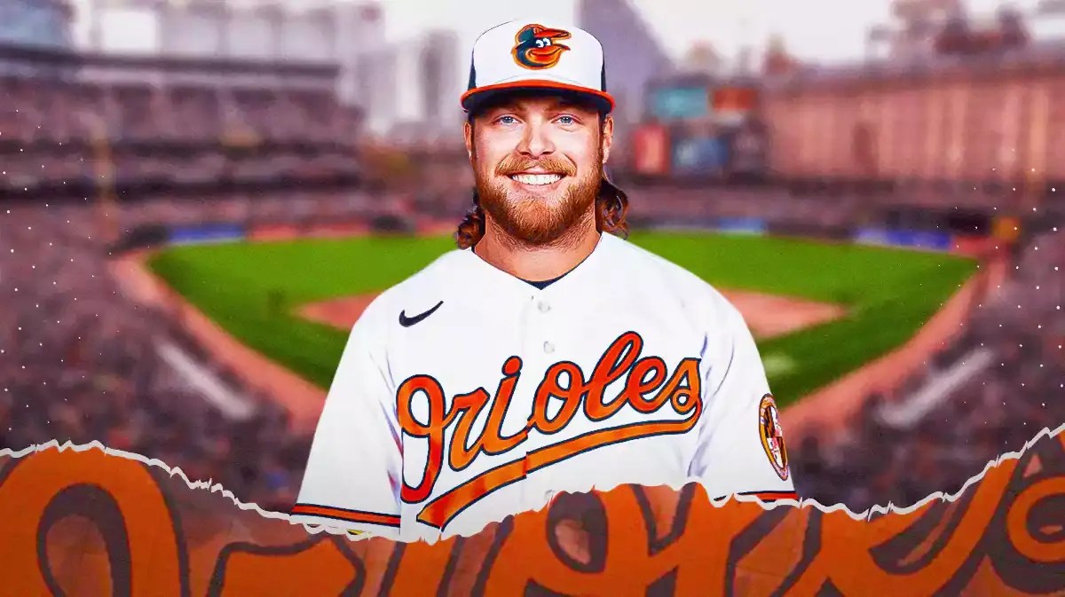 Former Brewers pitcher Corbin Burnes stands in front of Orioles stadium after an MLB trade, Joey Ortiz sits out of the frame
