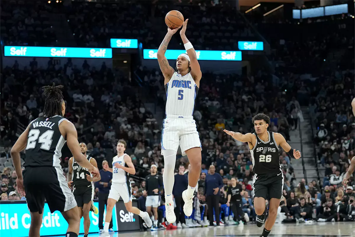 Orlando Magic forward Paolo Banchero (5) shoots between San Antonio Spurs guard Devin Vassell (24) and forward Dominick Barlow (26) in the second half at Frost Bank Center. 
