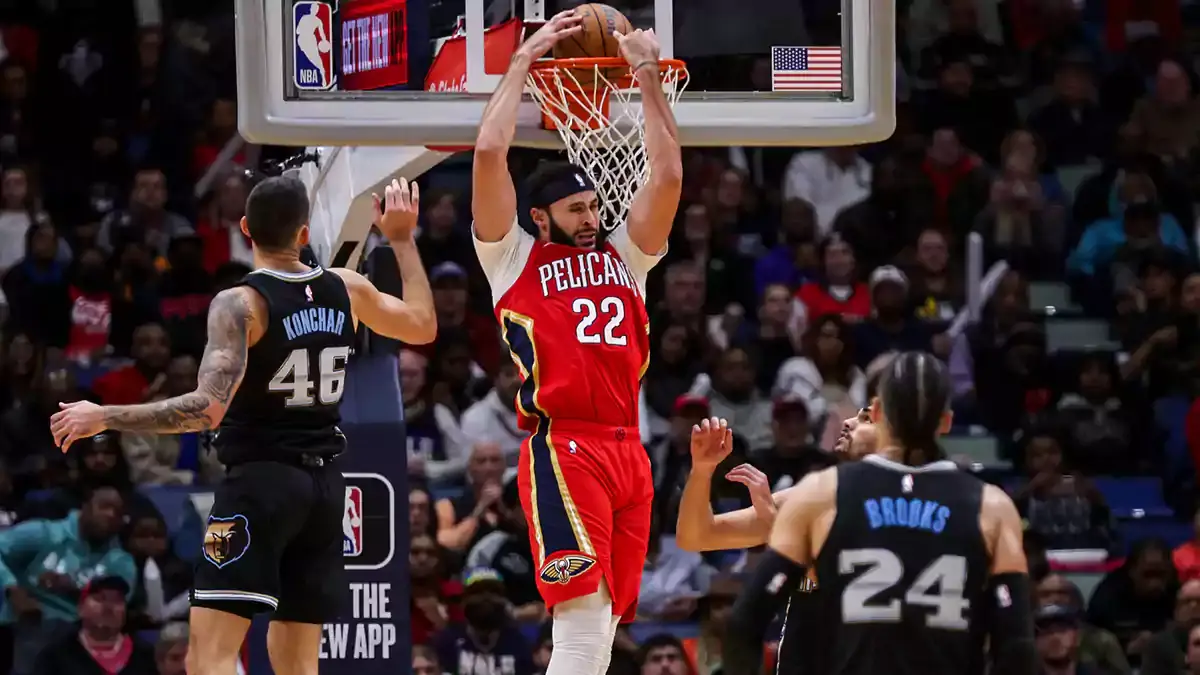 New Orleans Pelicans forward Larry Nance Jr. (22) reverse dunks the ball against Memphis Grizzlies guard John Konchar (46) during the second half at Smoothie King Center.