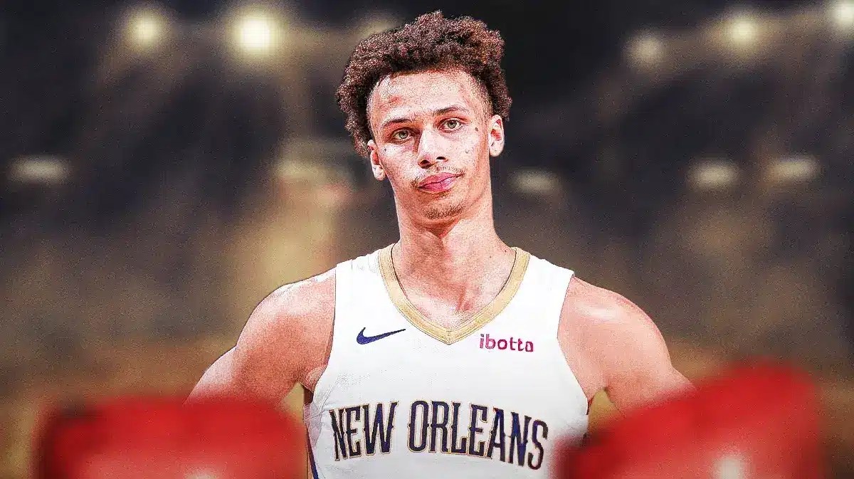 Pelicans' Dyson Daniels sitting down on an NBA sideline looking serious.