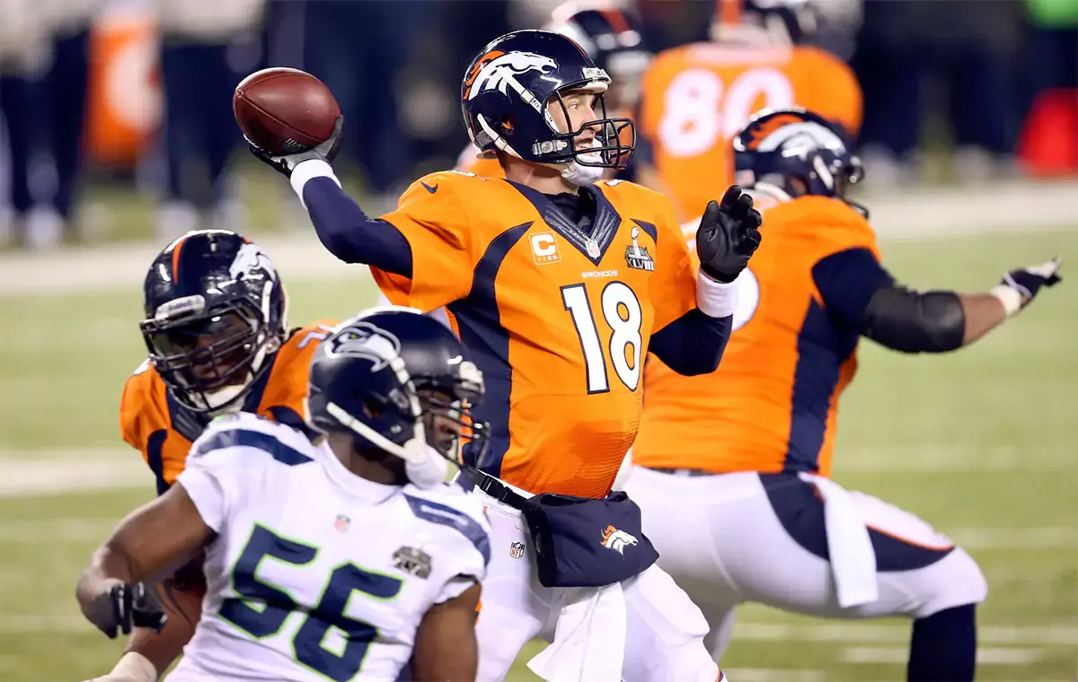 Denver Broncos quarterback Peyton Manning (18) throws a pass against the Seattle Seahawks in the third quarter in Super Bowl XLVIII at MetLife Stadium. 