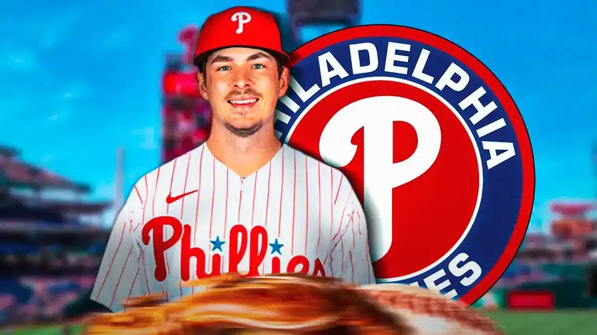 Michael Rucker wearing a Phillies uniform next to a Phillies logo at Citizen's Bank Park